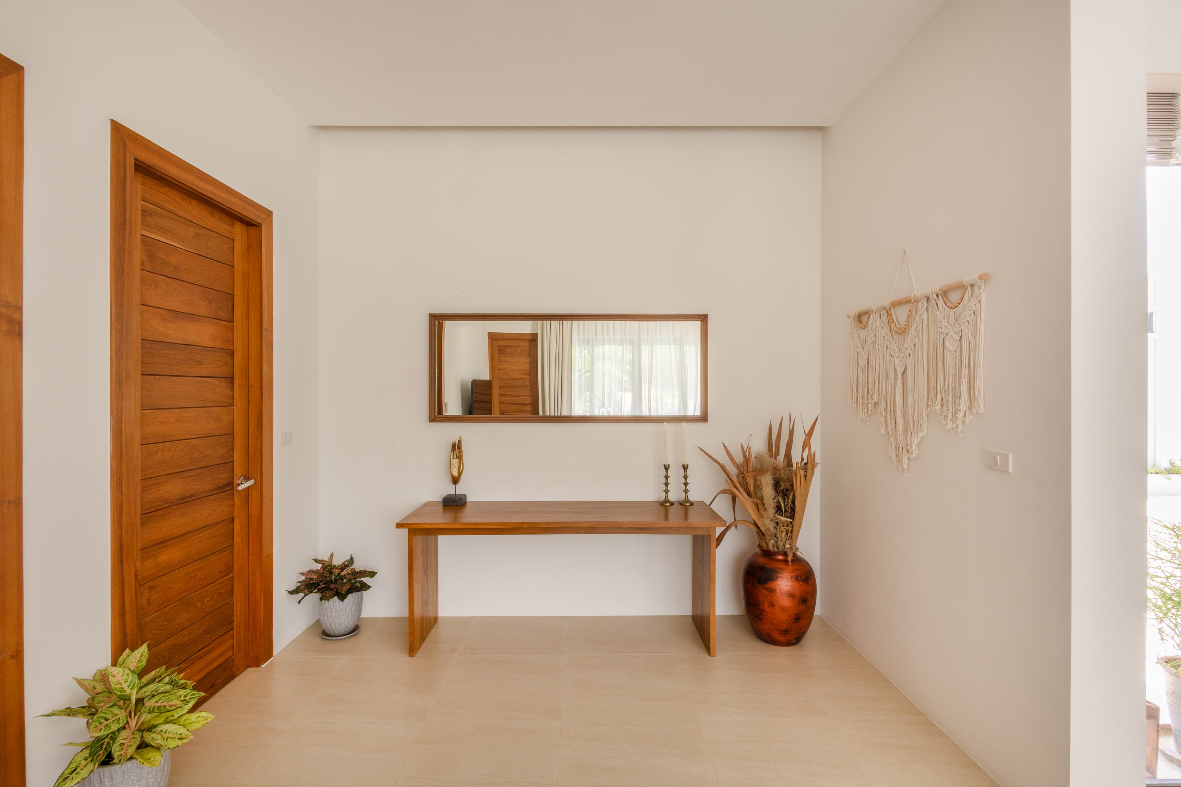 Villa entrance with teak door and console — Barefoot Villas