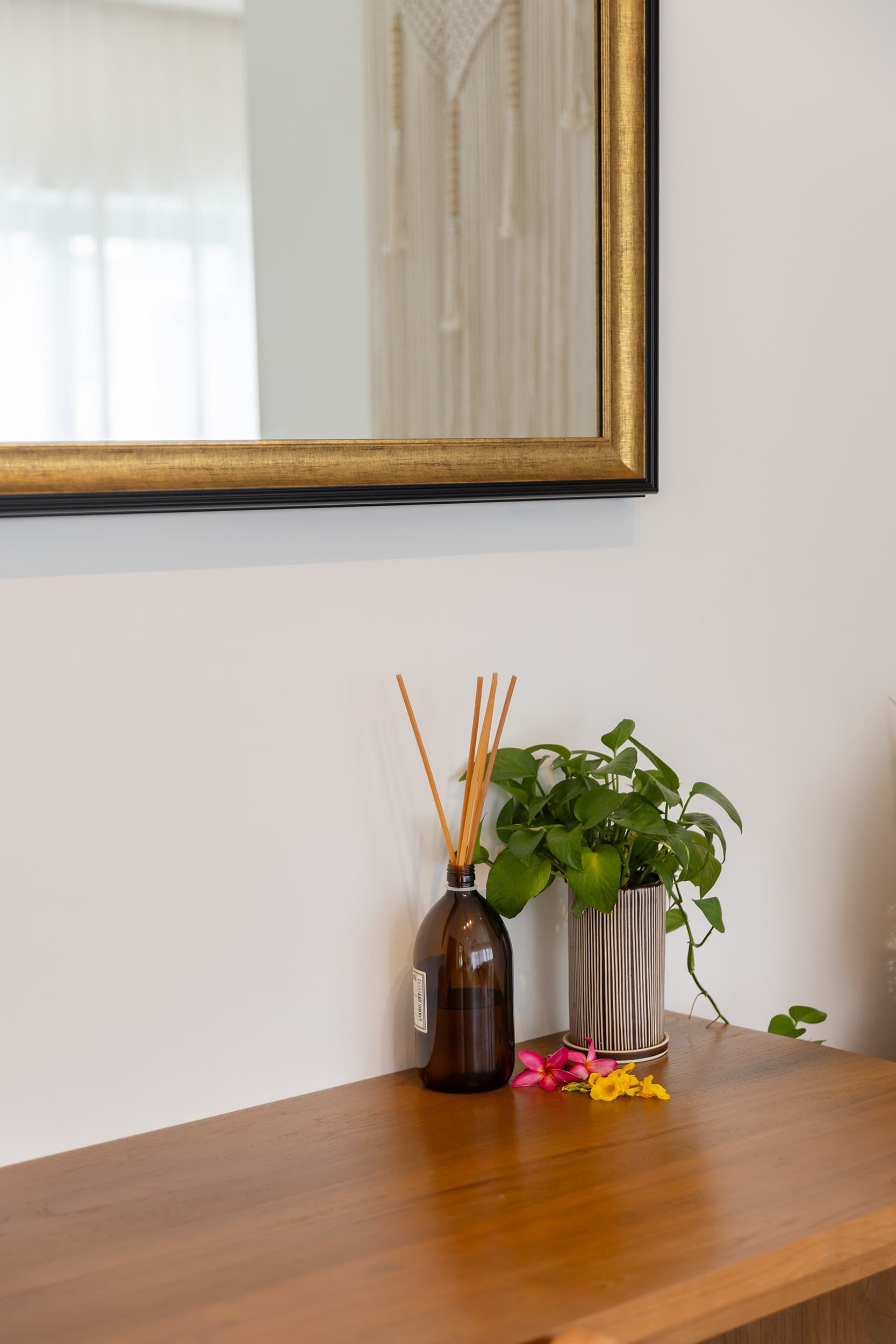 Villa details — reed diffuser and tropical flowers — Barefoot Villas
